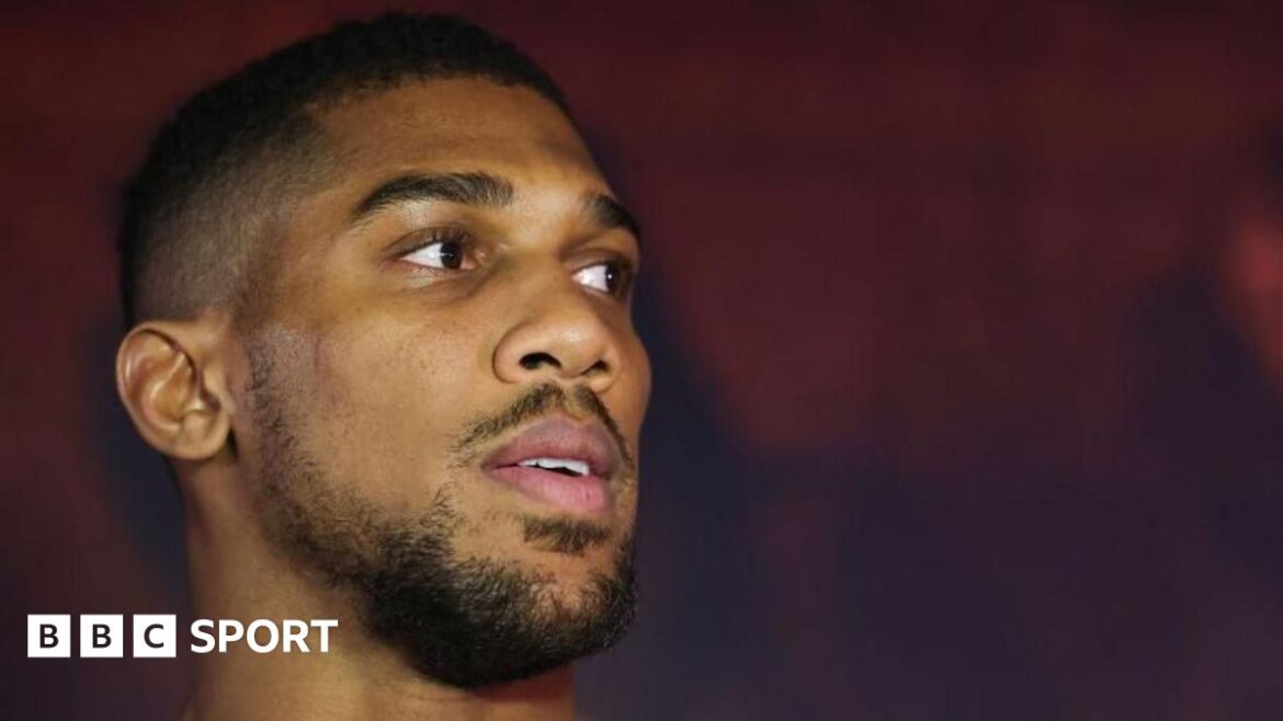 A picture of Anthony Joshua sat with four women