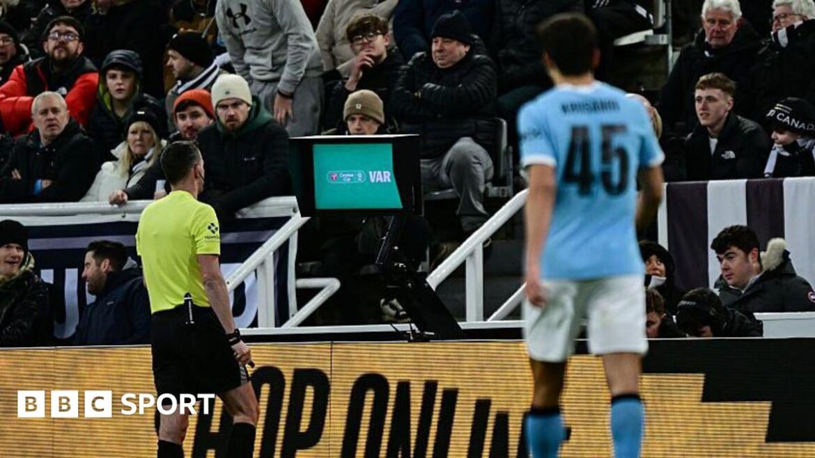 Chris Kavanagh at the pitch-side VAR monitor 