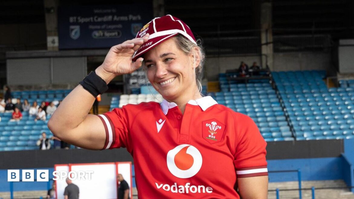 Kerin Lake smiling while wearing her 50th cap