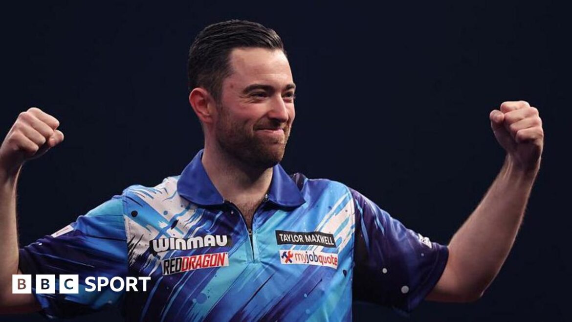 Luke Humphries raises his fists to celebrate after hitting a nine-darter at the World Masters 
