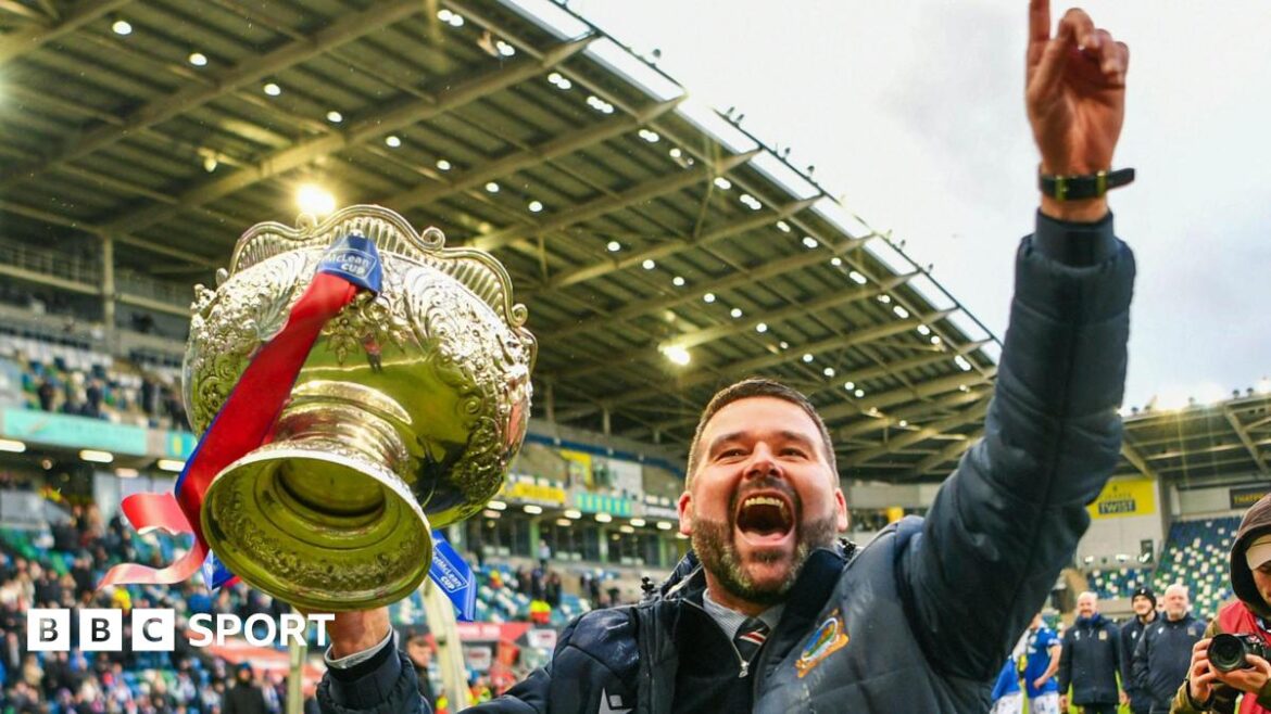 David Healy celebrates with trophy