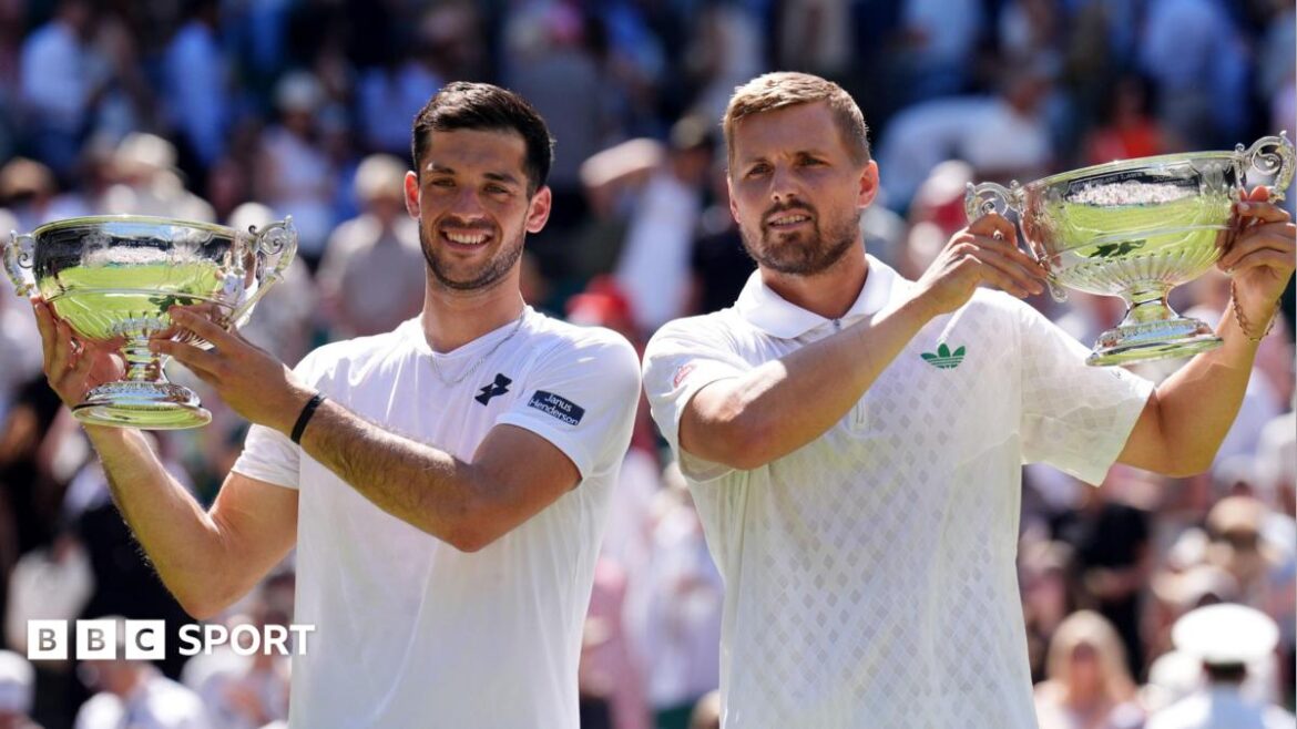 Julian Cash (left) and Lloyd Glasspool pose with their Wimbledon doubles trophies