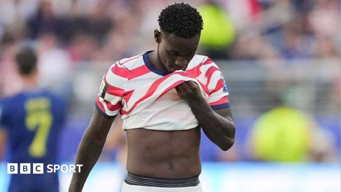 Folarin Balogun covers his face with his shirt after being sent off