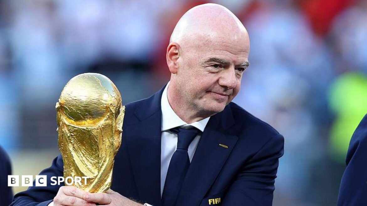 Gianni Infantino holds the World Cup trophy