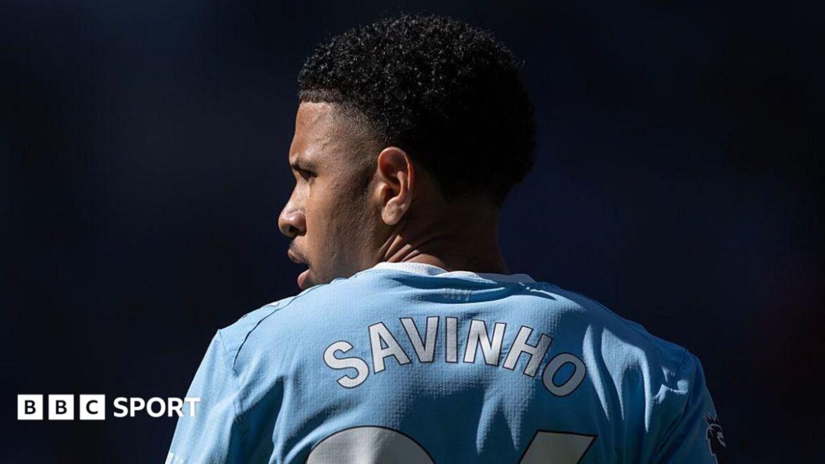 The back of Savino's shirt with his head turned to the side