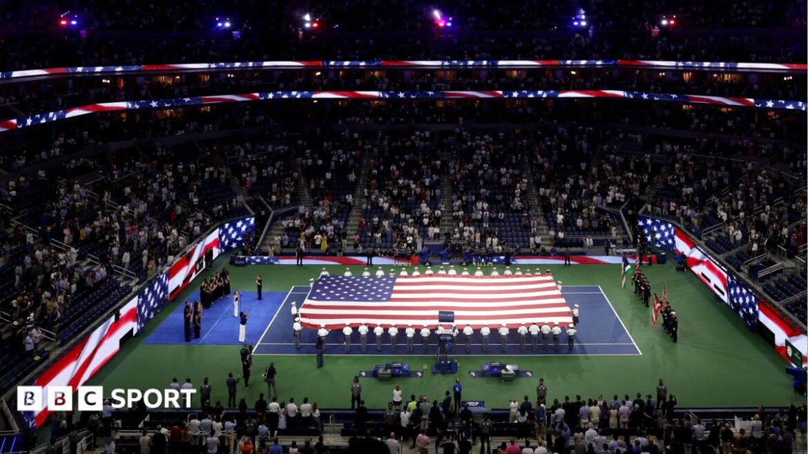 A giant flag is unfurled on the Arthur Ashe Stadium on the 25th anniversary of the 9/11 attacks
